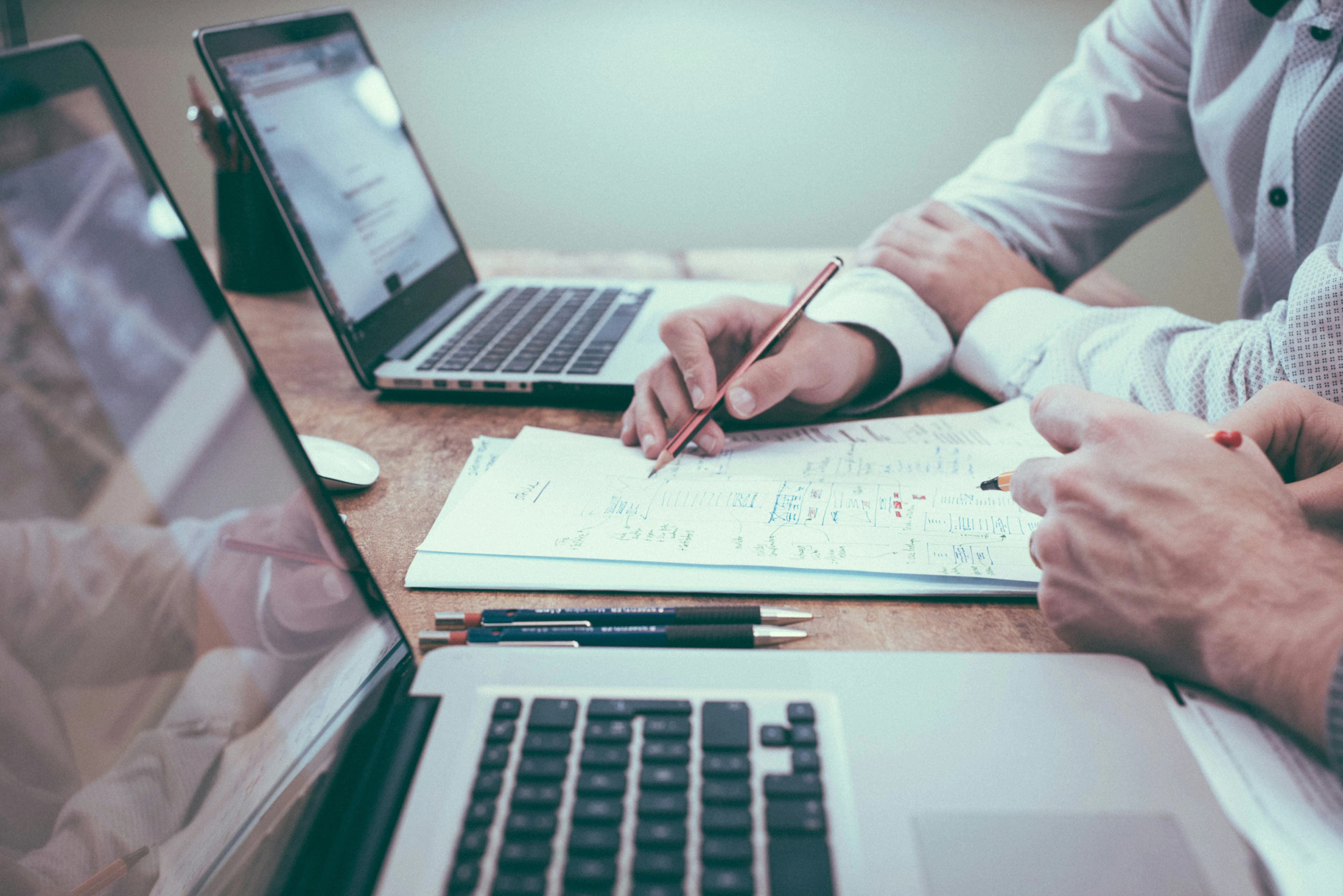 Financial planning documents and laptop on desk